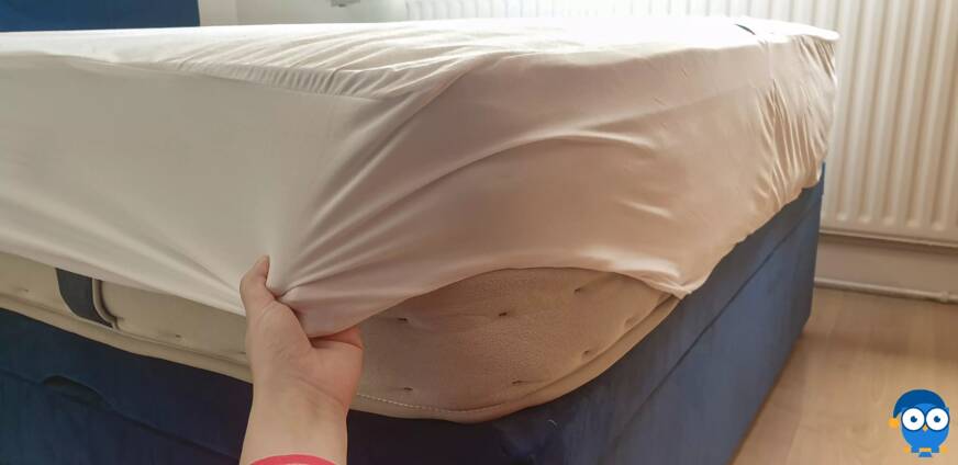 Putting on DreamCloud mattress protector